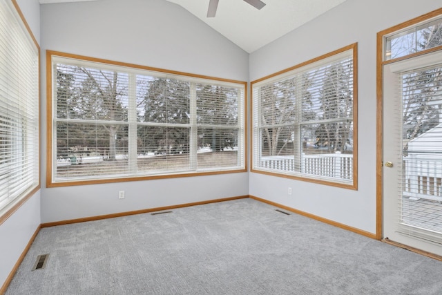 unfurnished sunroom featuring vaulted ceiling, plenty of natural light, visible vents, and ceiling fan