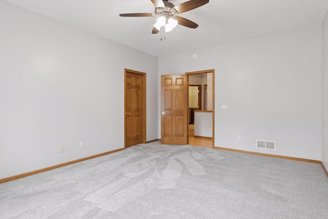 unfurnished bedroom with visible vents, baseboards, light carpet, and ceiling fan