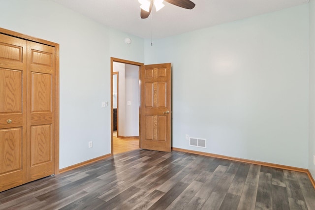 unfurnished bedroom with ceiling fan, visible vents, baseboards, and wood finished floors