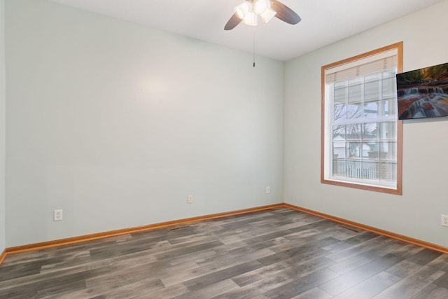 unfurnished room featuring baseboards, ceiling fan, and wood finished floors