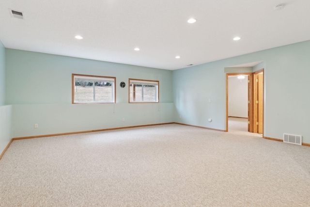 empty room with recessed lighting, visible vents, and light colored carpet