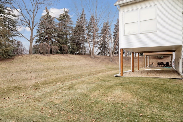 view of yard with a carport and a patio