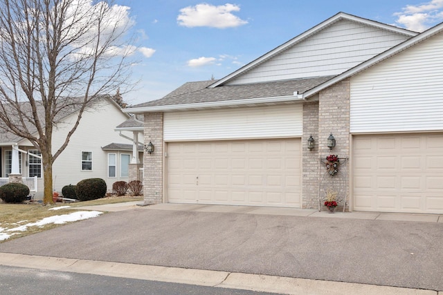 view of front of home featuring brick siding and a shingled roof