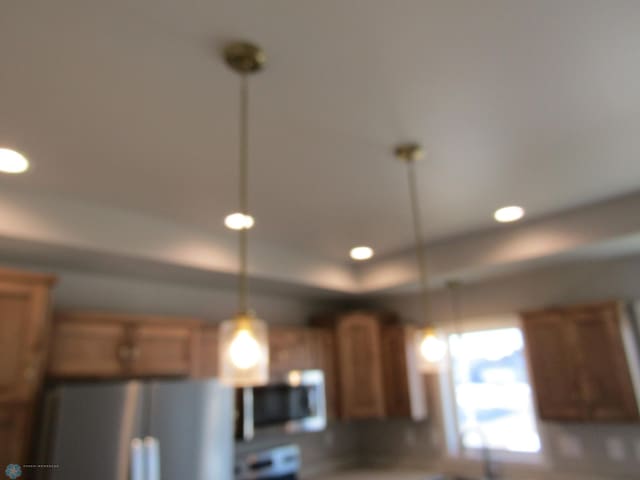 kitchen with refrigerator and decorative light fixtures