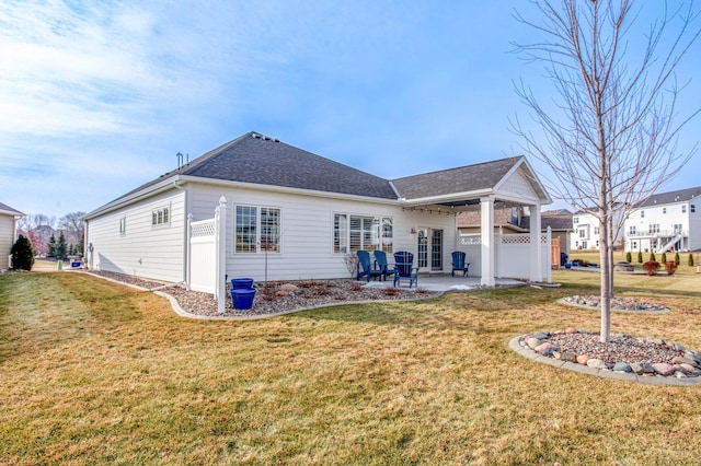 back of property featuring a patio and a lawn