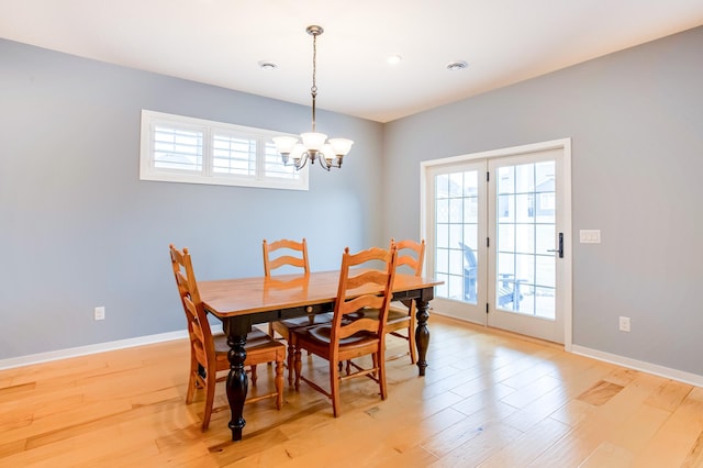 dining room featuring a chandelier and light wood-type flooring