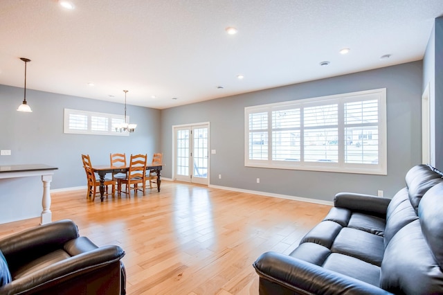 living room with french doors and light hardwood / wood-style flooring