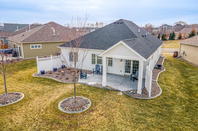 rear view of house featuring a patio area and a lawn