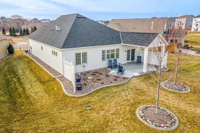 rear view of property with a lawn and a patio area