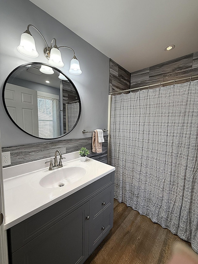 bathroom with a shower with curtain, wood finished floors, and vanity