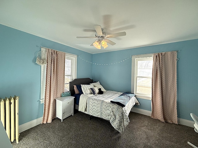 bedroom with dark carpet, radiator heating unit, ornamental molding, ceiling fan, and baseboards