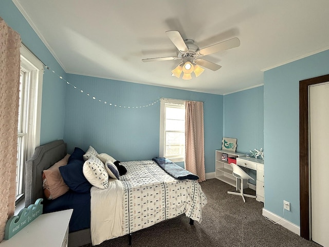 carpeted bedroom featuring crown molding, baseboards, and ceiling fan