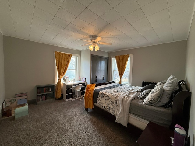 carpeted bedroom with ceiling fan and crown molding