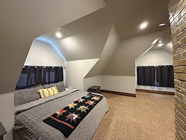 carpeted bedroom featuring vaulted ceiling and baseboards