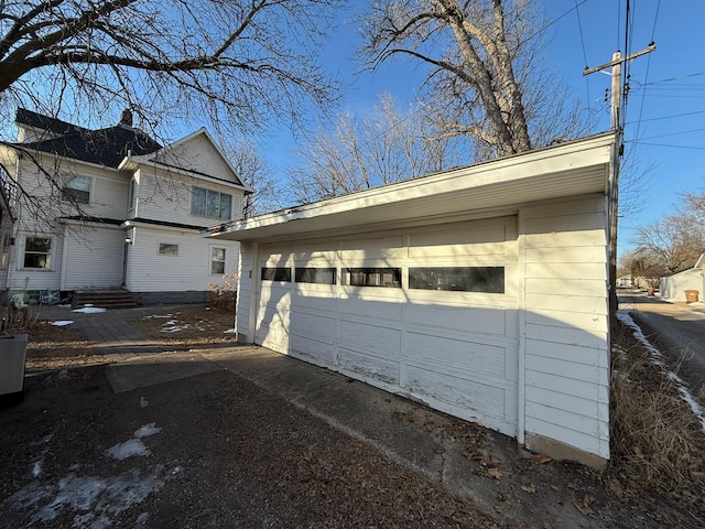 view of home's exterior with an outbuilding and a detached garage