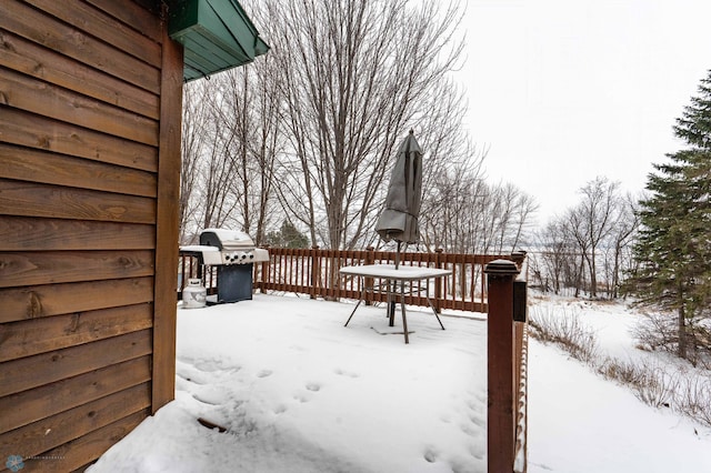 snow covered deck featuring area for grilling