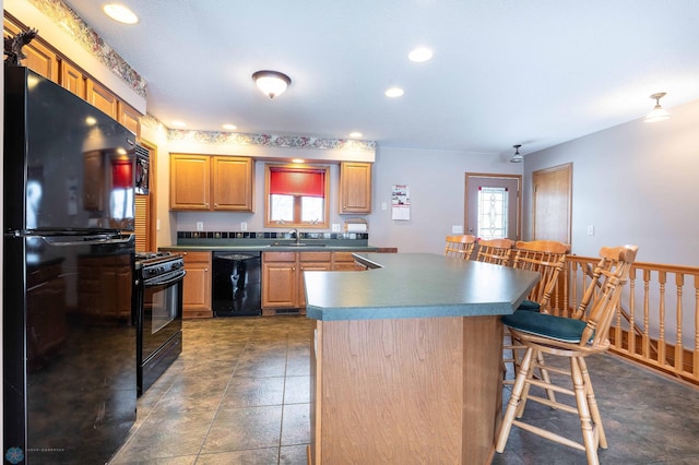 kitchen with black appliances, a kitchen island, a kitchen bar, and sink