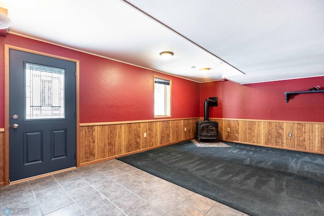 foyer featuring a wood stove