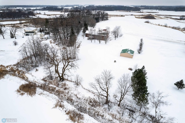 snowy aerial view featuring a rural view