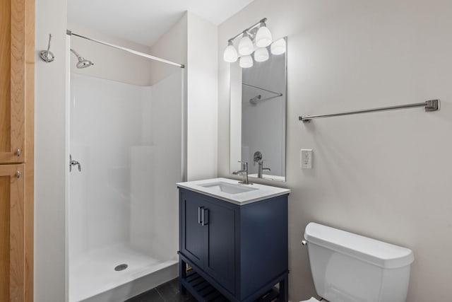 bathroom with tile patterned floors, a shower, vanity, and toilet