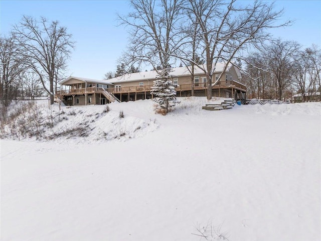 snow covered property featuring a deck