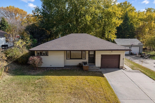 ranch-style house with an attached garage, driveway, roof with shingles, and a front yard