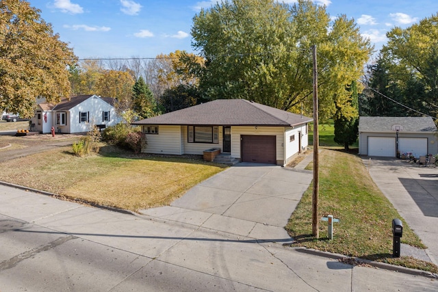 ranch-style home with an attached garage, driveway, and a front lawn