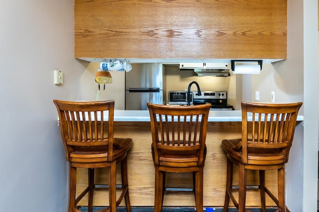 bar featuring stainless steel appliances