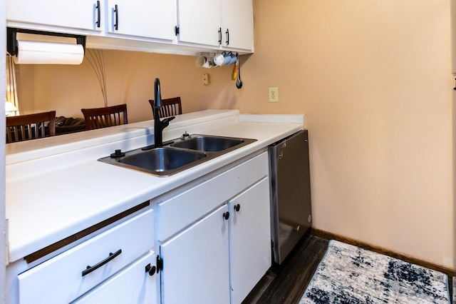 kitchen with dishwasher, white cabinetry, dark wood-type flooring, and sink