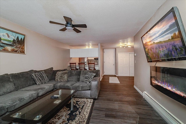 living room with ceiling fan, dark hardwood / wood-style flooring, a textured ceiling, and a baseboard radiator