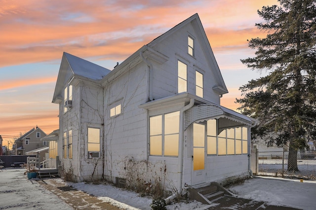 property exterior at dusk featuring cooling unit