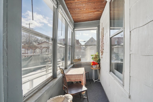 sunroom featuring wooden ceiling and a wealth of natural light