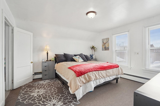 bedroom featuring dark colored carpet, a baseboard radiator, and vaulted ceiling