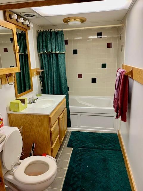 full bathroom with tile patterned floors, vanity, toilet, and shower / tub combo