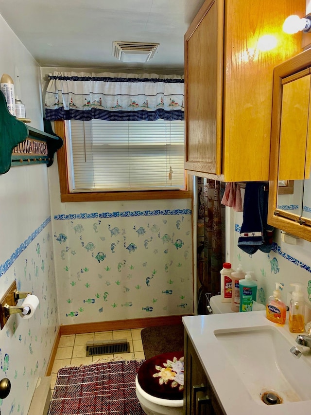 bathroom with tile patterned flooring, vanity, and toilet