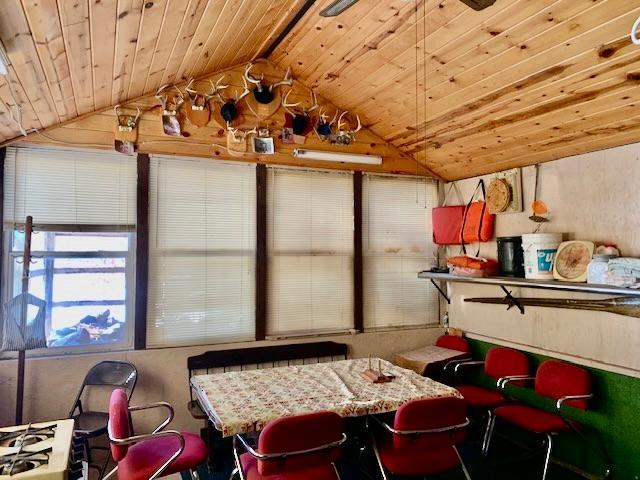 recreation room with vaulted ceiling with beams and wooden ceiling