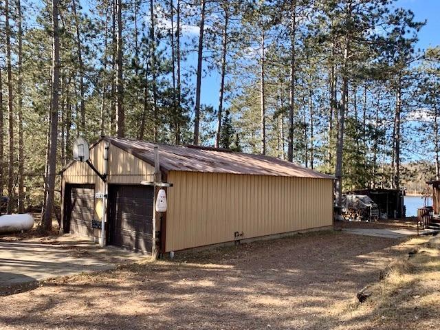 exterior space with a garage and an outbuilding