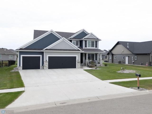 craftsman inspired home featuring a garage and a front yard