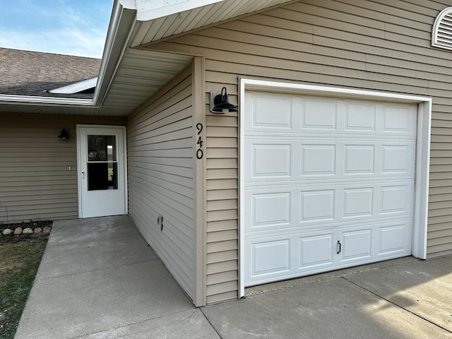 view of exterior entry with a garage