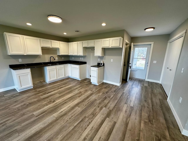 kitchen featuring white cabinetry, sink, and hardwood / wood-style floors