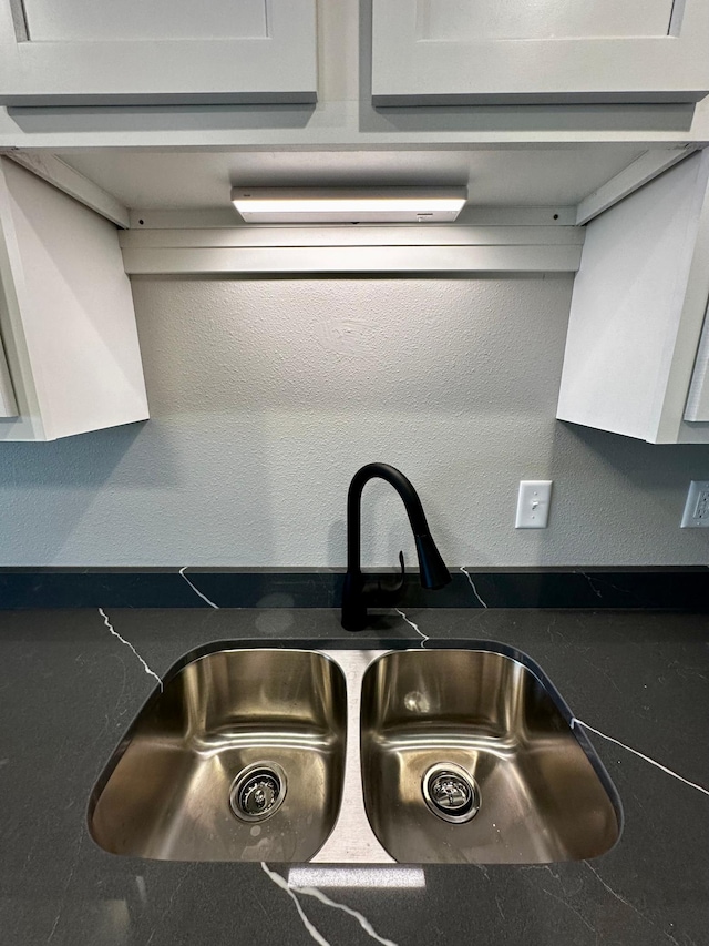 room details with white cabinetry and sink