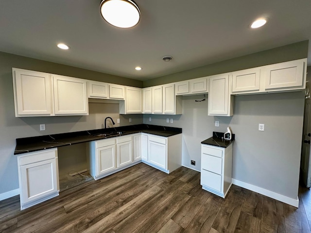 kitchen featuring sink, dark wood-type flooring, and white cabinets