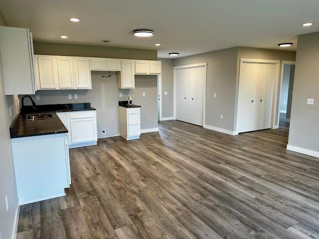 kitchen featuring white cabinetry, dark hardwood / wood-style floors, and sink