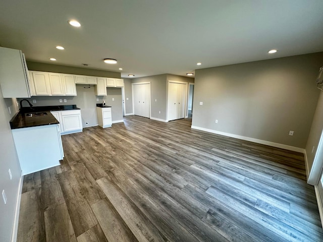 kitchen featuring white cabinetry, sink, and dark wood-type flooring