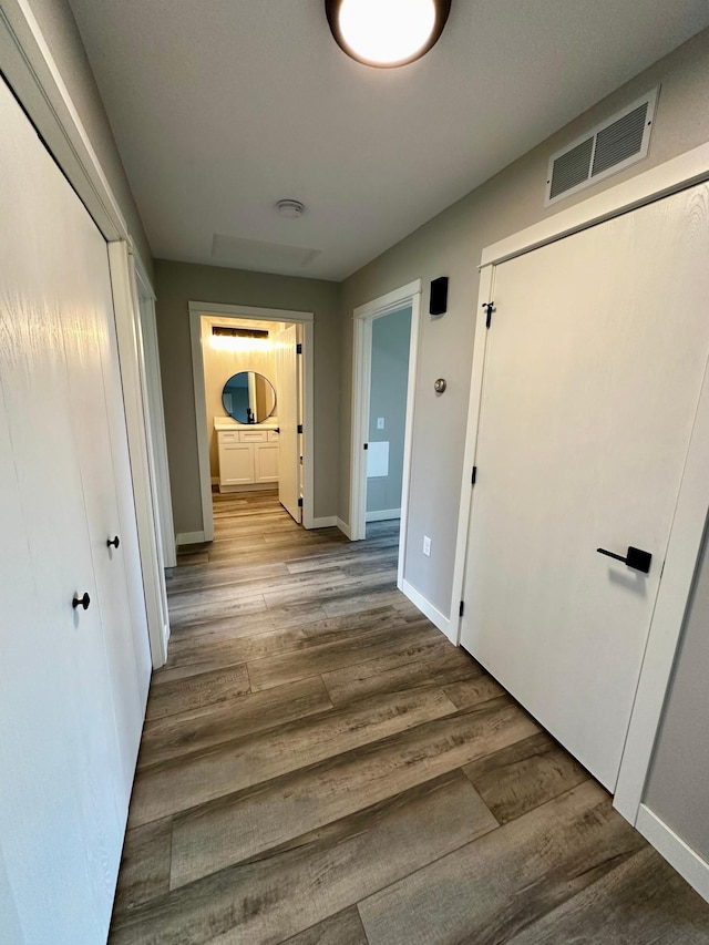 corridor featuring hardwood / wood-style floors