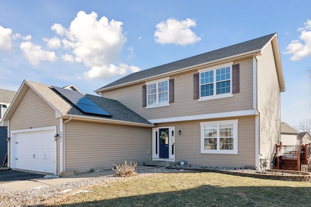 front facade with a front lawn, solar panels, and a garage