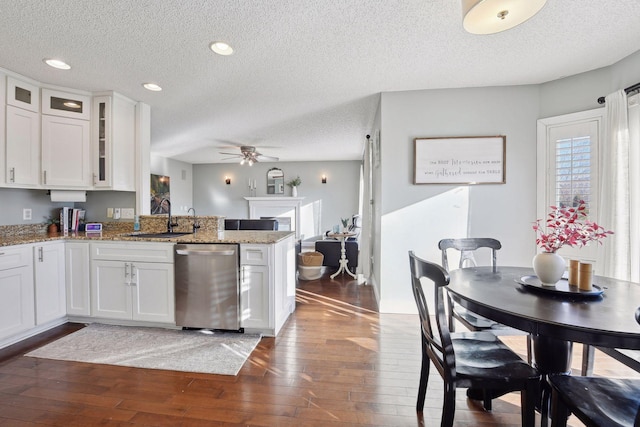 kitchen with sink, white cabinetry, stainless steel dishwasher, and a textured ceiling