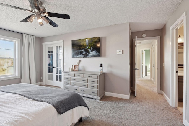 carpeted bedroom with ceiling fan and a textured ceiling