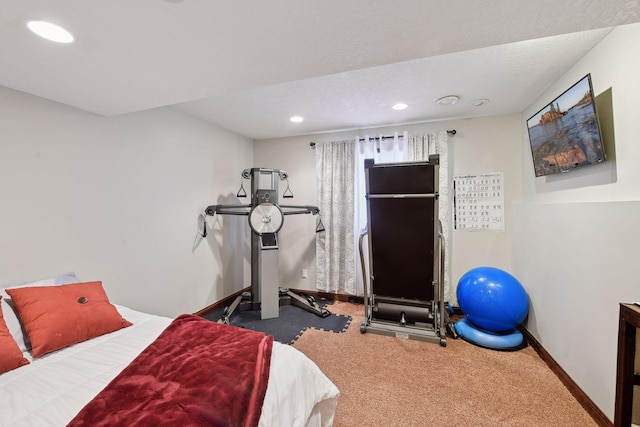 bedroom with a textured ceiling and carpet flooring