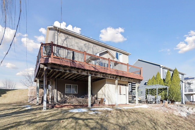 rear view of house with a pergola, a deck, and a yard